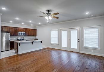 A kitchen with wooden cabinets and a white island.